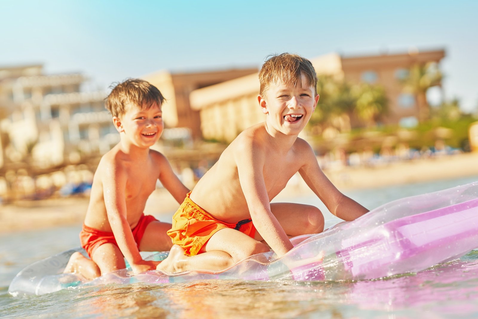 Two boys or brothers on mattress on Red Sea