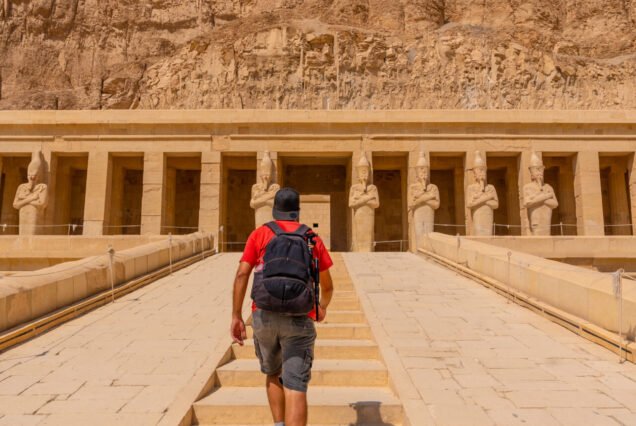 A young man on the entrance stairs to the Funerary Temple of Hatshepsut in Luxor